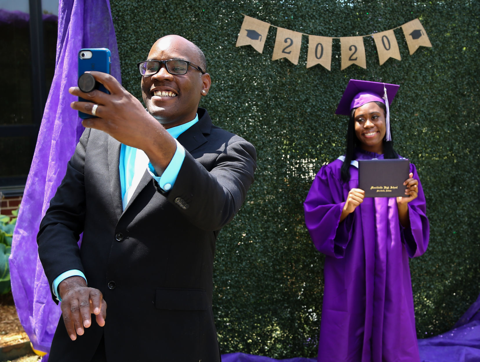 Merrillville High School seniors participate in a "drive-up" graduation